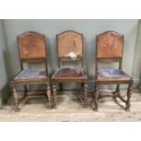 Three hide upholstered dining chairs with lobed and baluster turned oak legs