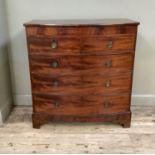 An early 19th century mahogany bow fronted chest of drawers having two short over three long