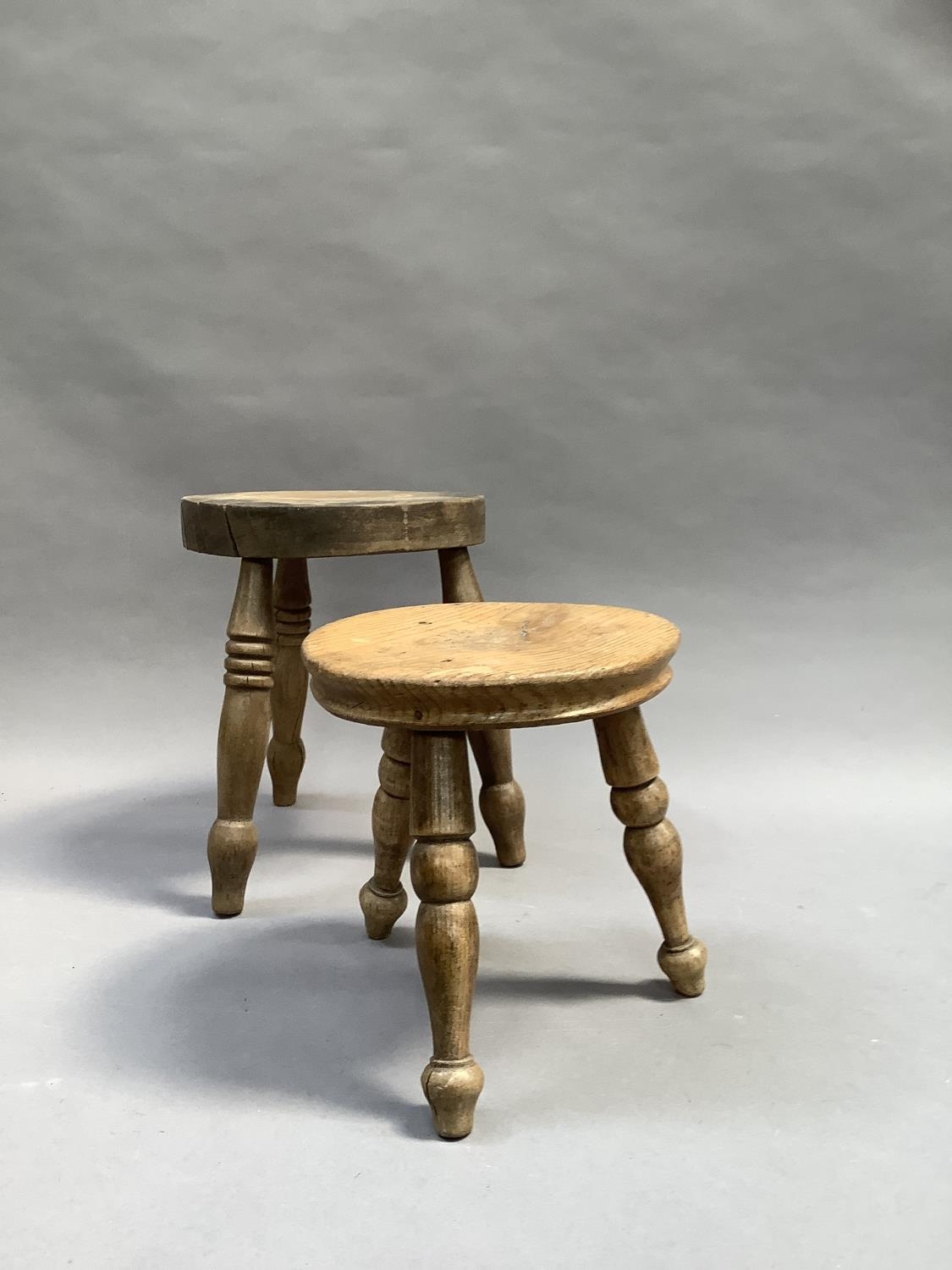 A cobbler's pine three legged stool together with another in beech