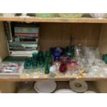 Ten emerald green glass wines and three water glasses together with cranberry glass bowls, green