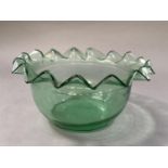 An early 20th century pale green glass bowl with wavy rim, 28cm diameter by 14cm high