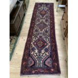 A modern Middle Eastern rug, the ivory field with three diamond shaped medallions amongst