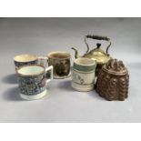 A copper jelly mould, a brass kettle with turned wooden handle and four various Victorian mugs