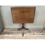 A 19th century mahogany rectangular tilt top table on turned column and tripod base, 77cm x 50cm