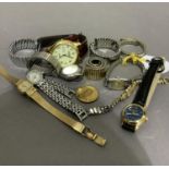 A collection of lady's and gentleman's wristwatches and watch bracelets