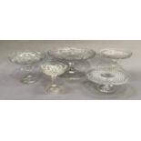 Three early 20th century moulded glass cake stands and two pedestal dishes