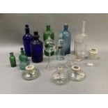 A collection of chemist bottles including a green poison bottle, flasks and jars, measures etc