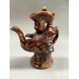 A Toby jug and lid of treacle glaze, 24cm high, (small chip to the spout and to the brim of his hat)