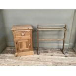 A pine bedside cabinet with drawer and cupboard on plinth base together with a towel rail