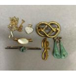 A Victorian knot brooch in pinchbeck together with a pair of mid 20th century ear pendants, a George