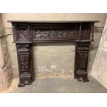 A Victorian oak fireplace, the mantlepiece with egg and dart moulded rim on turned uprights with