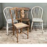 A pair of bleached beech rail back dining chairs on turned legs together with another with pierced