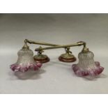 A pair of late Victorian/Edwardian brass wall sconces having circular fluted and beaded plates,