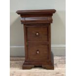 A mahogany finished bedside chest having a frieze drawer above two deep drawers with turned handles,