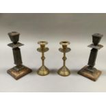 A pair of cast iron aesthetic candlesticks, late 19th century, of square section, the sconce and