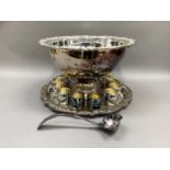 A silver plated punch bowl and stand having a shell and grapevine cast border, a set of twelve punch