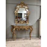 18th century style gilt console mirror and table, the mirror of arched outline with pierced shell