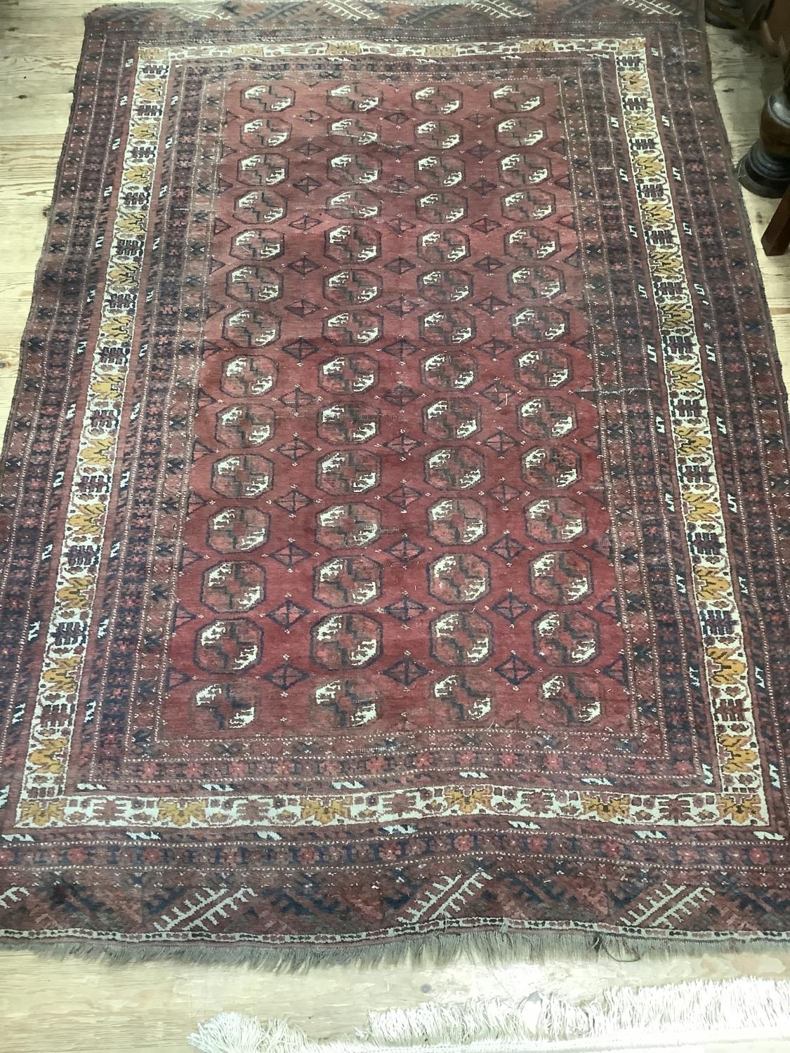 A Bokhara rug of crimson ground with four rows of elephant feet medallions within multiple - Image 2 of 4