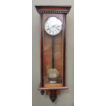 A late 19th century walnut and ebonized case Vienna wall clock with architectural pediment, flared