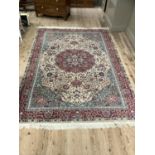 A wool carpet of Persian design in red, pale camel, green and blue, 293cm x 205cm
