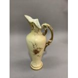 A Royal Worcester ewer having a moulded and pierced neck and lid, the tapered body printed and