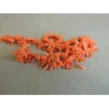 An early 20th century stick coral necklace with 9ct barrel snap fastener, approximate length 80mm,