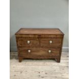 An early 19th century mahogany crossbanded chest of two short and one long drawer with boxwood