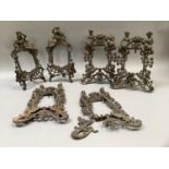 Two pairs of Victorian coppered cast iron photograph frames surmounted with crowned female and