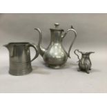 A pewter coffee pot, a pewter tankard with spout and a cream jug