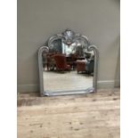 A wall mirror of arched profile with foliate cresting, moulded pewter coloured frame, 104cm wide x