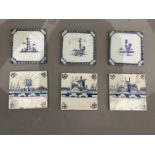 Six Delft blue and white tiles, three painted with coastal houses and shipping and three in the
