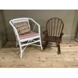 A white painted wicker armchair together with a child's rail back rocking chair