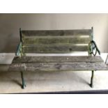 A garden bench with wrought iron rustic ends and wooden slats, 137cm wide