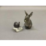 A Royal Copenhagen figure of a rabbit eating a lettuce leaf and another of a mouse nibbling on a