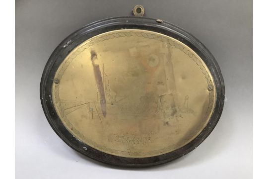 An oval brass ship's plaque etched with a scene of a fishing boat in a harbour entitled 'Parmelia' - Image 1 of 2