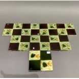 A set of eight Victorian tiles moulded as four squares, two with plant forms and two plain, in