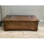 A low set coffee table/chest having a lift up top and drawers fitted to one side on bracket feet
