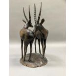 An African carved harwood group of two oryx, 40.5cm high