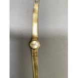 A Longines lady's wristwatch c.1974 in 18ct gold case on an integral Milanese bracelet, jewelled