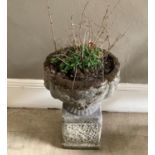 A cast concrete garden urn and plinth, 59cm high