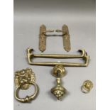 A collection of door furniture including a pair of bar style handles, 38cm long, a lion mask door