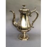 A silver plated coffee pot by James Dixon and Son of panelled baluster form having a domed cover