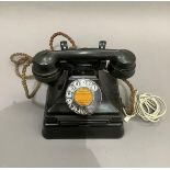 A GPO vintage black Bakelite telephone with plinth