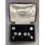 A pair of George V mother of pearl set cufflinks in 18ct gold together with two matching batons,