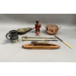 A pair of brass faced bellows, poker, toasting fork, tongs, a copper two handled pan, pewter