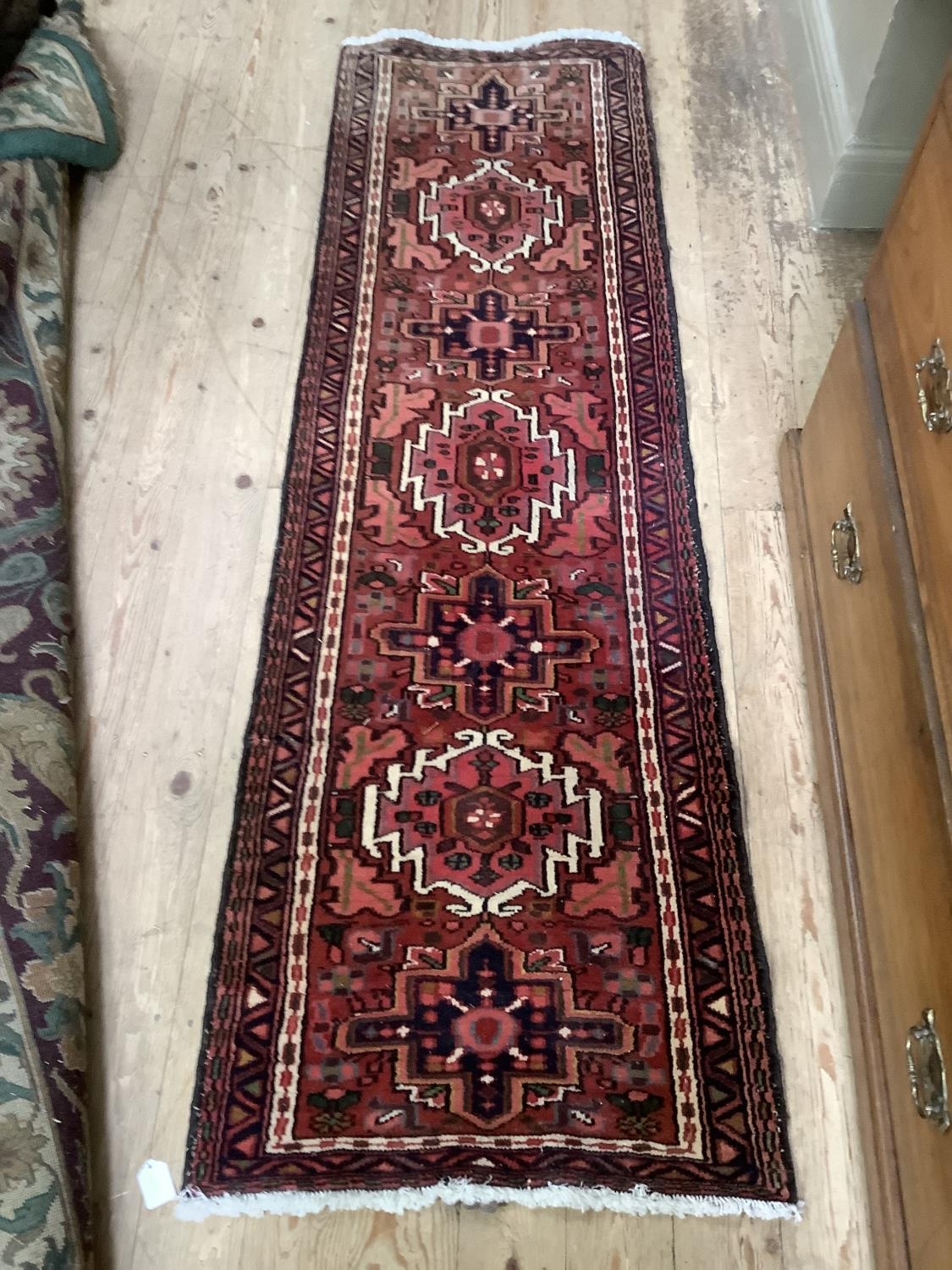 A modern Middle Eastern runner, the red field with alternating medallions within stylised leaf forms - Image 2 of 4