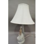 A Nao lamp modelled as a country girl with sheep, 45cm to fittings approximately