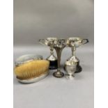 Two silver two handled trophy cups 9.25cm high and with plinth 13.5cm, Birmingham 1932 together with