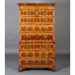 AN OYSTER VENEER WALNUT CHEST ON CHEST, crossbanded, having a moulded cornice above a plain