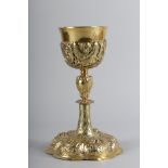 A 19th CENTURY AND LATER GILT METAL CHALICE, the cup held within a sleeve pierced with cherubs,